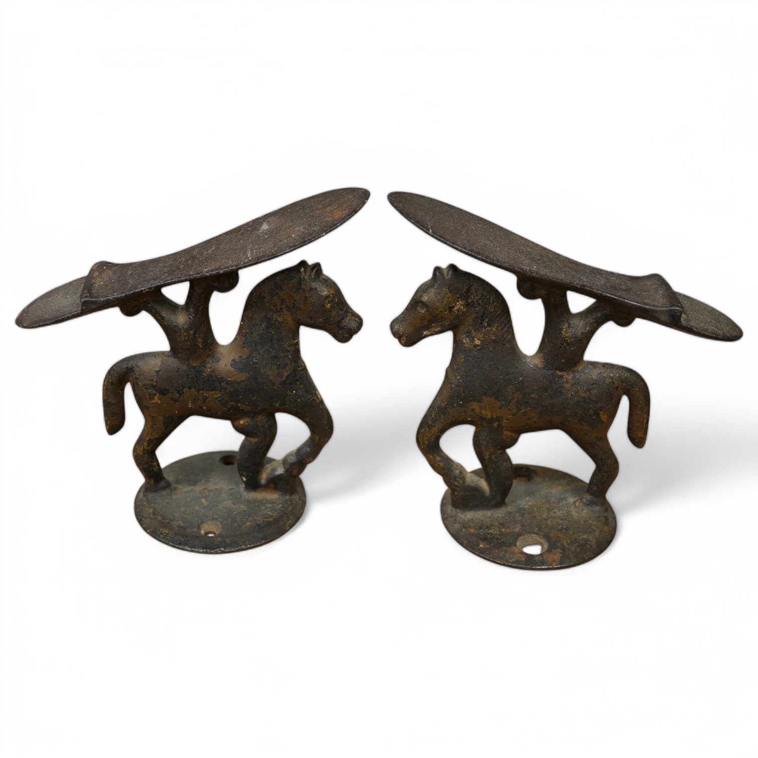 A small pair of novelty iron ‘horse’ boot scrapers. 18cm high. Condition - poor, base mounts missing